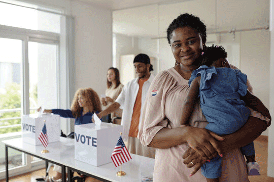 women and child at the voting booth.